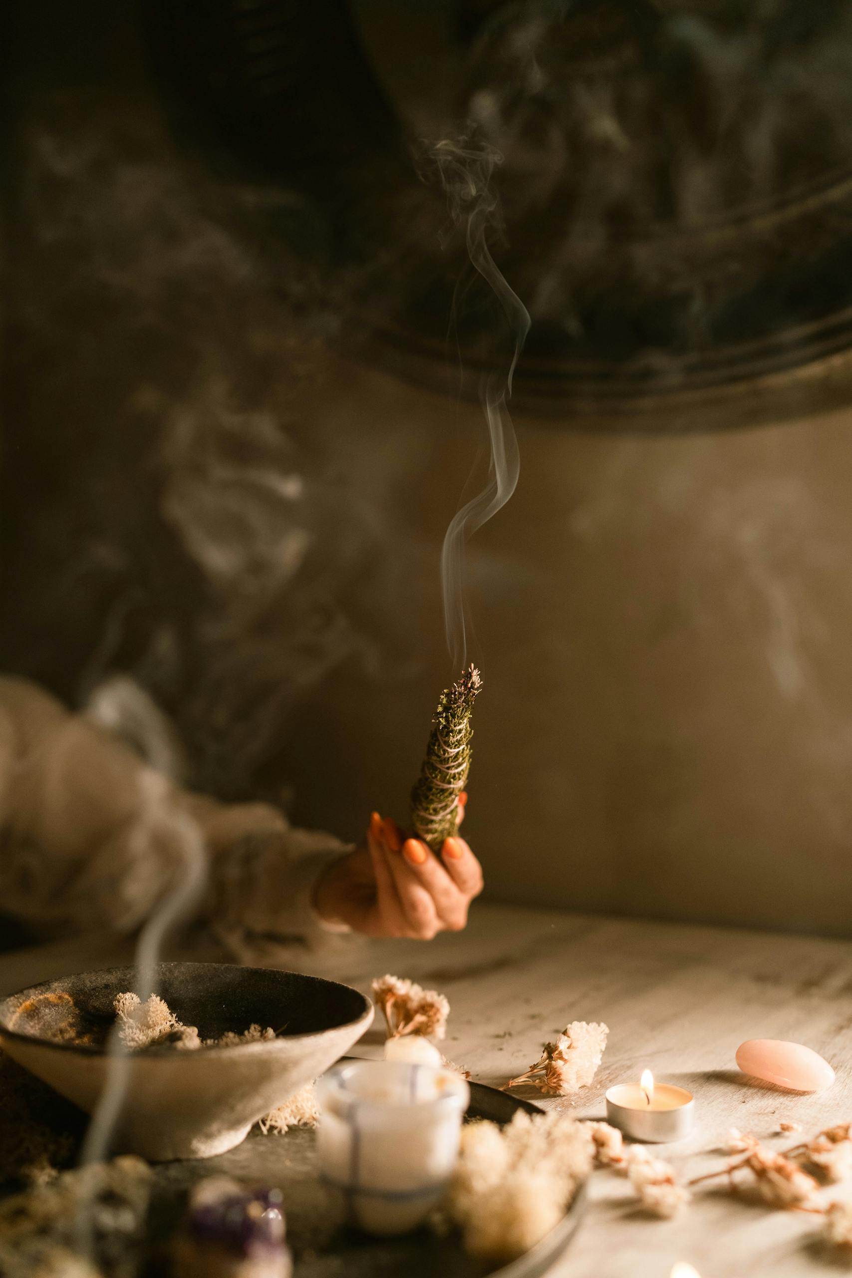 Person Holding a Smoking Weed