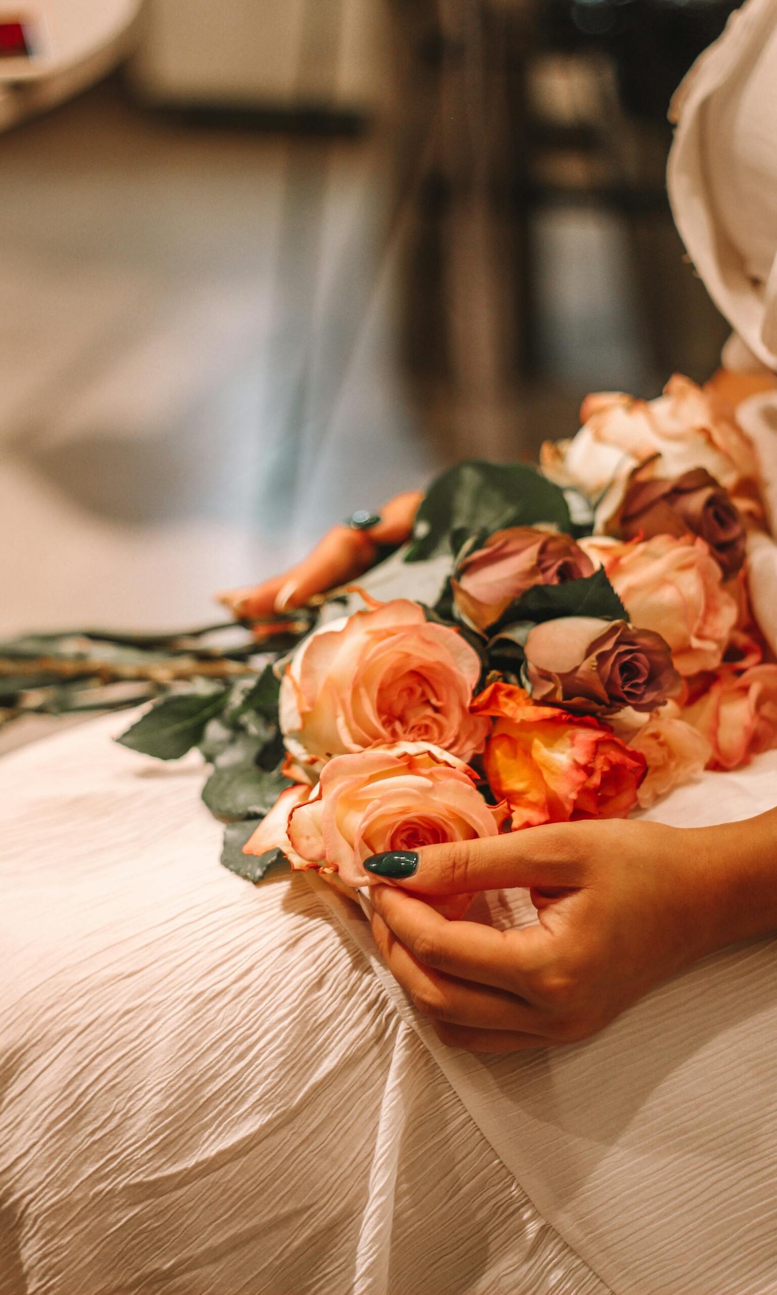 Person Sitting with Bouquet of Flowers on Lap